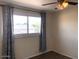 Bright bedroom with curtains, a ceiling fan, and a window, creating a cozy atmosphere at 4517 S Grandview Ave, Tempe, AZ 85282