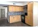 Updated kitchen with wooden cabinets, modern appliances, and a stylish backsplash at 4517 S Grandview Ave, Tempe, AZ 85282