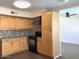 Bright kitchen with wood cabinets, updated appliances, and tiled backsplash at 4517 S Grandview Ave, Tempe, AZ 85282