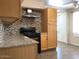 Modern kitchen with wood cabinets, granite countertops, tiled backsplash and updated appliances at 4517 S Grandview Ave, Tempe, AZ 85282
