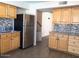 Well-lit kitchen featuring wood cabinets, stainless steel refrigerator, and mosaic backsplash at 4517 S Grandview Ave, Tempe, AZ 85282