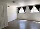 Spacious living room with neutral paint, two windows, wood-style flooring and closet at 4517 S Grandview Ave, Tempe, AZ 85282