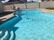 Backyard pool with a concrete block wall, rock border and submerged pool cleaner at 4517 S Grandview Ave, Tempe, AZ 85282
