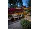 Cozy back patio with striped furniture, ambient lighting, and decorative plants for a comfortable retreat at 5018 E Kathleen Rd, Scottsdale, AZ 85254