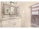 Bright bathroom vanity with custom cabinets, marble countertop, and large framed mirror at 5018 E Kathleen Rd, Scottsdale, AZ 85254