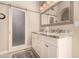 Elegant bathroom boasts dual sinks, a stone countertop, modern lighting, and a sliding privacy door at 5018 E Kathleen Rd, Scottsdale, AZ 85254