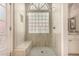 Bright bathroom shower with a glass block window and built-in bench for a luxurious, spa-like experience at 5018 E Kathleen Rd, Scottsdale, AZ 85254