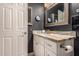 Modern bathroom boasts an elegant vanity with a stone countertop, a decorative mirror, and updated fixtures at 5018 E Kathleen Rd, Scottsdale, AZ 85254