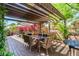 Outdoor dining area with a large table and seating, perfect for enjoying meals in a serene and landscaped backyard at 5018 E Kathleen Rd, Scottsdale, AZ 85254