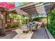 Outdoor dining area under a pergola, perfect for al fresco meals and gatherings in a private setting at 5018 E Kathleen Rd, Scottsdale, AZ 85254