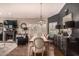 Elegant dining room with hardwood floors, a rustic table, modern chandelier, and stylish decor at 5018 E Kathleen Rd, Scottsdale, AZ 85254