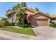 Charming single-story home with a well-manicured lawn, palm tree, and flowering bougainvillea at 5018 E Kathleen Rd, Scottsdale, AZ 85254