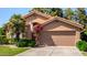 Lovely home with vibrant bougainvillea, a green lawn, and a neutral-toned facade under a clear blue sky at 5018 E Kathleen Rd, Scottsdale, AZ 85254