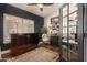Charming home office with a large window with shutters, a dark accent wall, and ample room for working at home at 5018 E Kathleen Rd, Scottsdale, AZ 85254