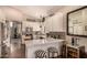 Bright kitchen featuring white cabinets, stainless steel appliances, bar seating and open floor plan at 5018 E Kathleen Rd, Scottsdale, AZ 85254