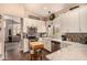 Well-lit kitchen features white cabinets, stainless steel appliances and view to living room at 5018 E Kathleen Rd, Scottsdale, AZ 85254