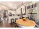 Charming kitchen with white cabinets, stainless appliances, breakfast nook, and modern lighting at 5018 E Kathleen Rd, Scottsdale, AZ 85254