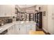 Bright kitchen featuring an island, white cabinets, stainless appliances, and a view to breakfast nook at 5018 E Kathleen Rd, Scottsdale, AZ 85254