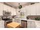 This kitchen boasts white cabinets, granite countertops, and stainless steel appliances at 5018 E Kathleen Rd, Scottsdale, AZ 85254