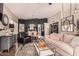 Open-concept living area with hardwood floors, stylish seating, and dining space with dark accent wall at 5018 E Kathleen Rd, Scottsdale, AZ 85254
