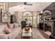 Elegant living room with high ceilings, a fireplace, stylish furniture, and dark hardwood floors at 5018 E Kathleen Rd, Scottsdale, AZ 85254