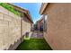 Narrow side yard with artificial turf, offering a low-maintenance outdoor space with easy access at 5018 E Kathleen Rd, Scottsdale, AZ 85254