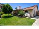 Beautiful backyard featuring a covered patio, lush lawn, and mature landscaping for added privacy at 556 W Sagebrush St, Gilbert, AZ 85233