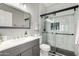 Bathroom with glass enclosed shower, gray vanity, and tile flooring at 556 W Sagebrush St, Gilbert, AZ 85233