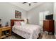 Bedroom with a ceiling fan, bright window, dresser, and wood flooring at 556 W Sagebrush St, Gilbert, AZ 85233