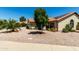 Street view of a one-story house featuring desert landscaping, a tile roof and a mature tree at 556 W Sagebrush St, Gilbert, AZ 85233