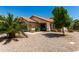Attractive single-story home featuring desert landscaping, a tile roof and mature palm trees at 556 W Sagebrush St, Gilbert, AZ 85233
