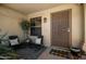 Welcoming front porch with cushioned chairs, decorative rug and plants, creating a cozy entrance at 556 W Sagebrush St, Gilbert, AZ 85233