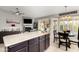 Open kitchen area with stainless steel appliances and dark wooden cabinets at 556 W Sagebrush St, Gilbert, AZ 85233