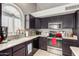 Kitchen with stainless steel appliances and dark wooden cabinets at 556 W Sagebrush St, Gilbert, AZ 85233
