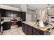 Kitchen with stainless steel appliances, dark wood cabinets, and a kitchen island at 556 W Sagebrush St, Gilbert, AZ 85233