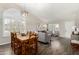 Open-concept living and dining area featuring modern furniture and a wood dining table at 556 W Sagebrush St, Gilbert, AZ 85233