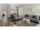 Bright living room featuring modern furniture, including gray sofas and a neutral-toned rug at 556 W Sagebrush St, Gilbert, AZ 85233