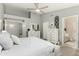 Bright main bedroom with vaulted ceilings, ensuite access, ceiling fan, and white furnishings at 556 W Sagebrush St, Gilbert, AZ 85233
