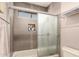 Bathroom with tiled shower, glass door, built-in niche, and sleek gray finishes at 630 E Jensen St # 116, Mesa, AZ 85203