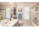 Well-lit bathroom featuring a large mirror and shower with convenient shelving at 630 E Jensen St # 116, Mesa, AZ 85203