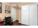 Office/bedroom with vinyl floors, closet with sliding doors, and Southwest-themed artwork at 630 E Jensen St # 116, Mesa, AZ 85203