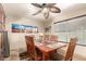 This dining room is well-lit and includes a ceiling fan, tile floors, and seating for six at 630 E Jensen St # 116, Mesa, AZ 85203