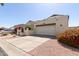 Attached two-car garage and driveway, with beautiful desert landscaping enhancing curb appeal at 630 E Jensen St # 116, Mesa, AZ 85203