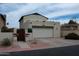 Charming stucco home featuring a garage, gated front yard, and low-maintenance desert landscaping at 630 E Jensen St # 116, Mesa, AZ 85203