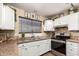 Updated kitchen featuring white cabinetry, stainless steel appliances, and ample counter space at 630 E Jensen St # 116, Mesa, AZ 85203