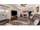 The inviting living room features a fireplace, ceiling fan, and sliding glass door to the backyard at 630 E Jensen St # 116, Mesa, AZ 85203