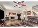 Cozy living room with fireplace, tile flooring, ceiling fan, and access to the backyard patio at 630 E Jensen St # 116, Mesa, AZ 85203