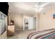 Bright main bedroom featuring a ceiling fan, carpet, and view into the main bathroom at 630 E Jensen St # 116, Mesa, AZ 85203