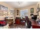 Comfortable home office space with rich wood desk, shelving, and decorative accents at 630 E Jensen St # 116, Mesa, AZ 85203