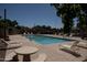 Inviting community pool surrounded by lounge chairs, tables, and desert landscaping at 630 E Jensen St # 116, Mesa, AZ 85203